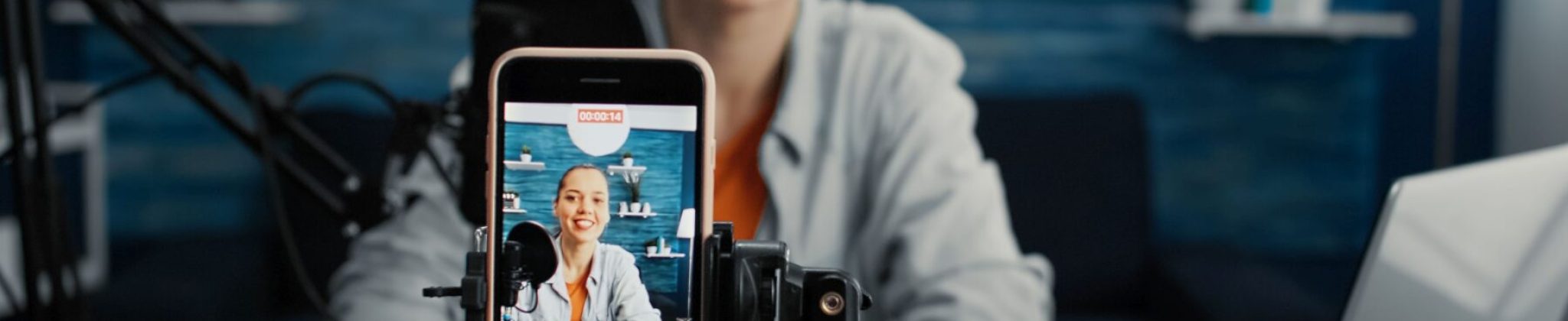 Attractive social media influencer sitting at home studio desk while starting streaming